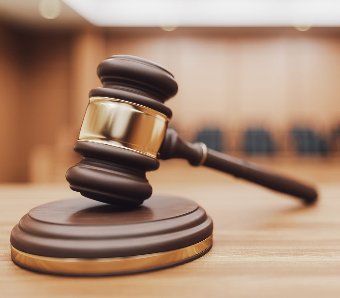 Judge's gavel on courtroom table