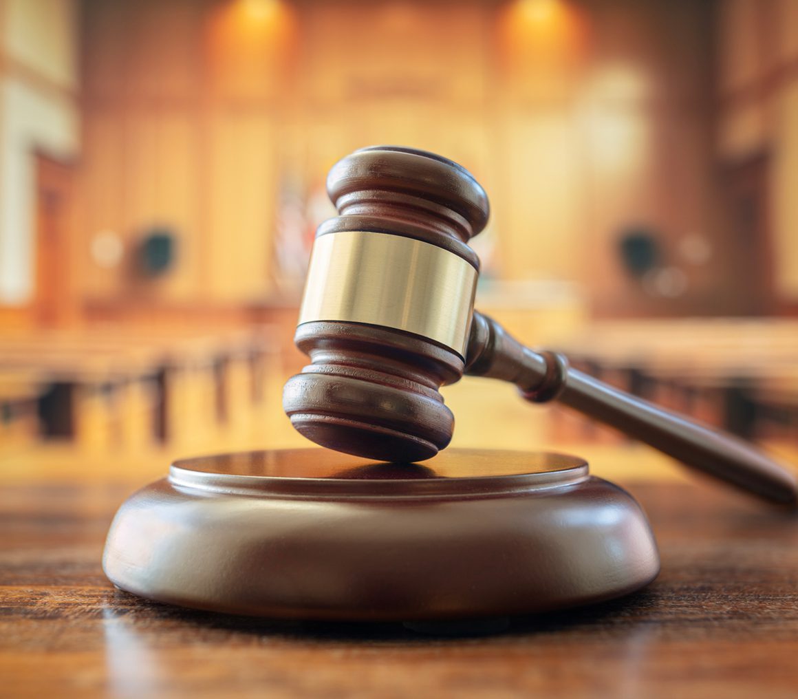 Judge's gavel in empty courtroom